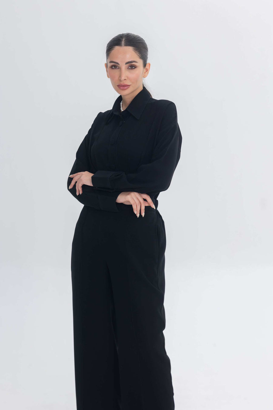 Woman wearing Essense Folds black chic and modest inner set for layering under abaya