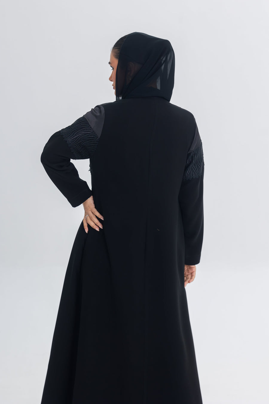 Black Satin Eclipse abaya with crepe and lace detailing, elegant flowing silhouette with hood.