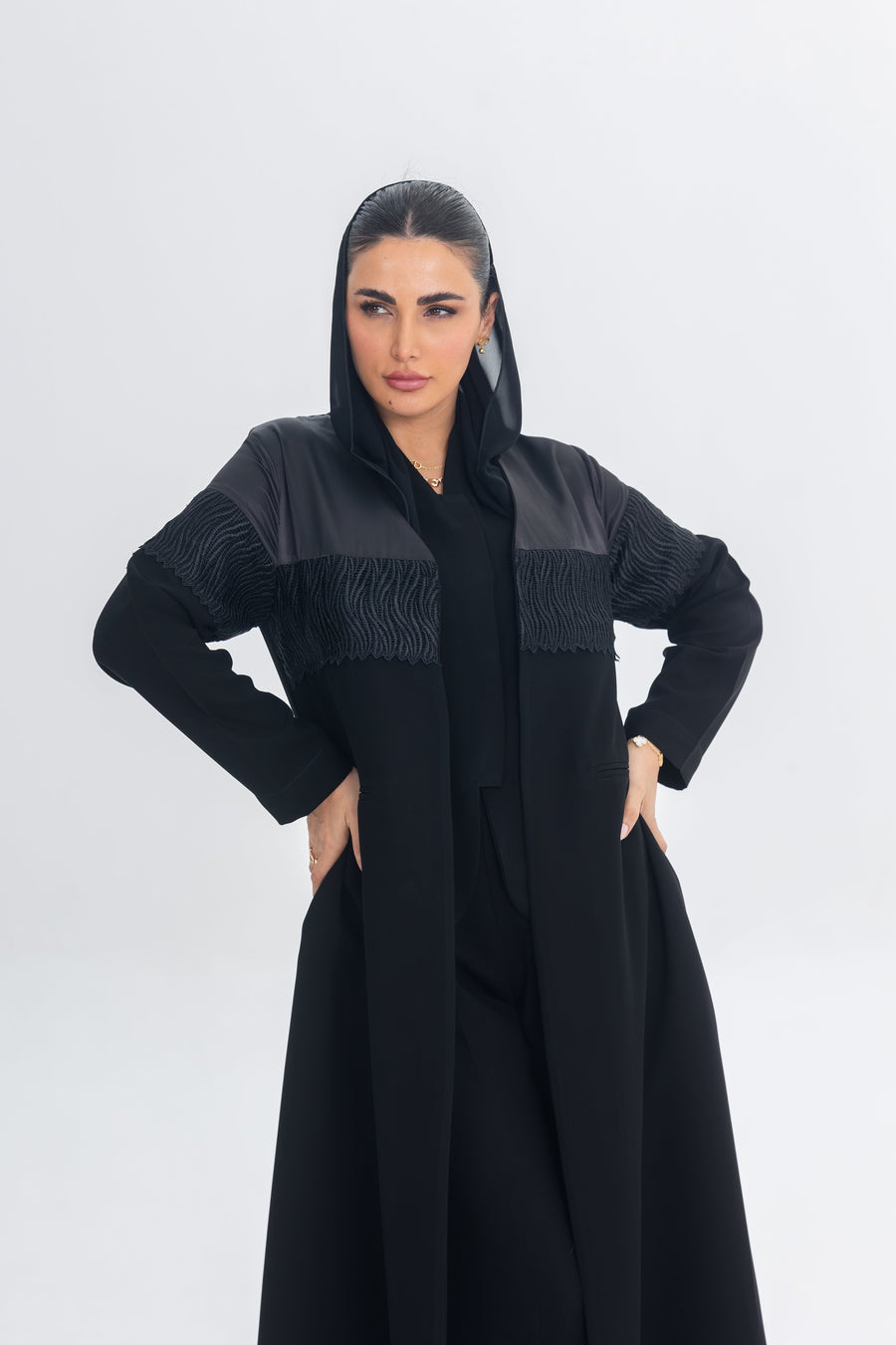 Black satin and crepe abaya with lace detailing and a regal elegant design.