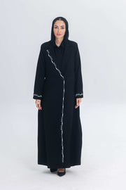 Woman wearing Pearl Noir black crepe blazer abaya with white pearl and bead embroidery detailing