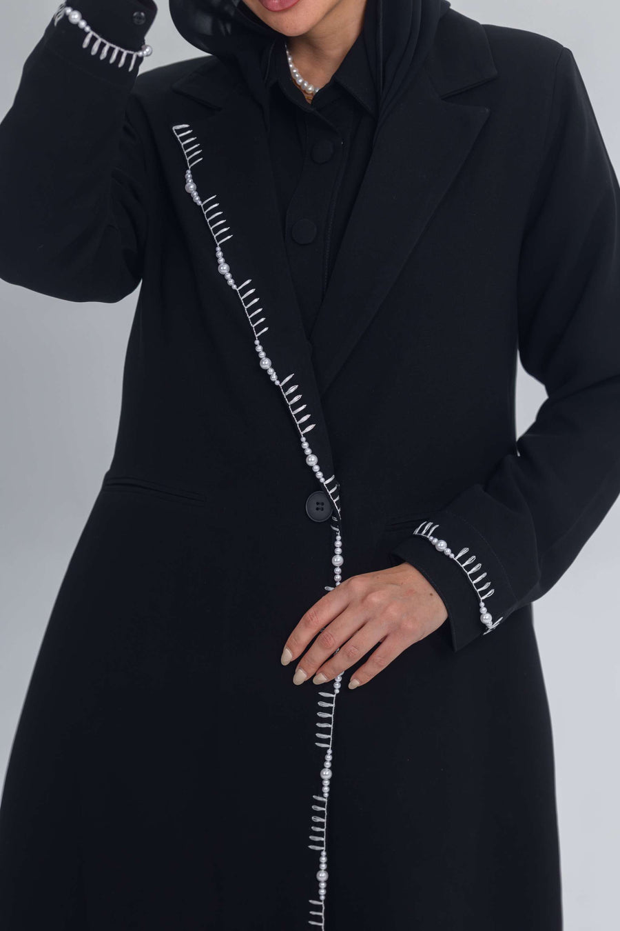Black crepe blazer abaya with white pearl and bead embroidery detailing on front and cuffs.