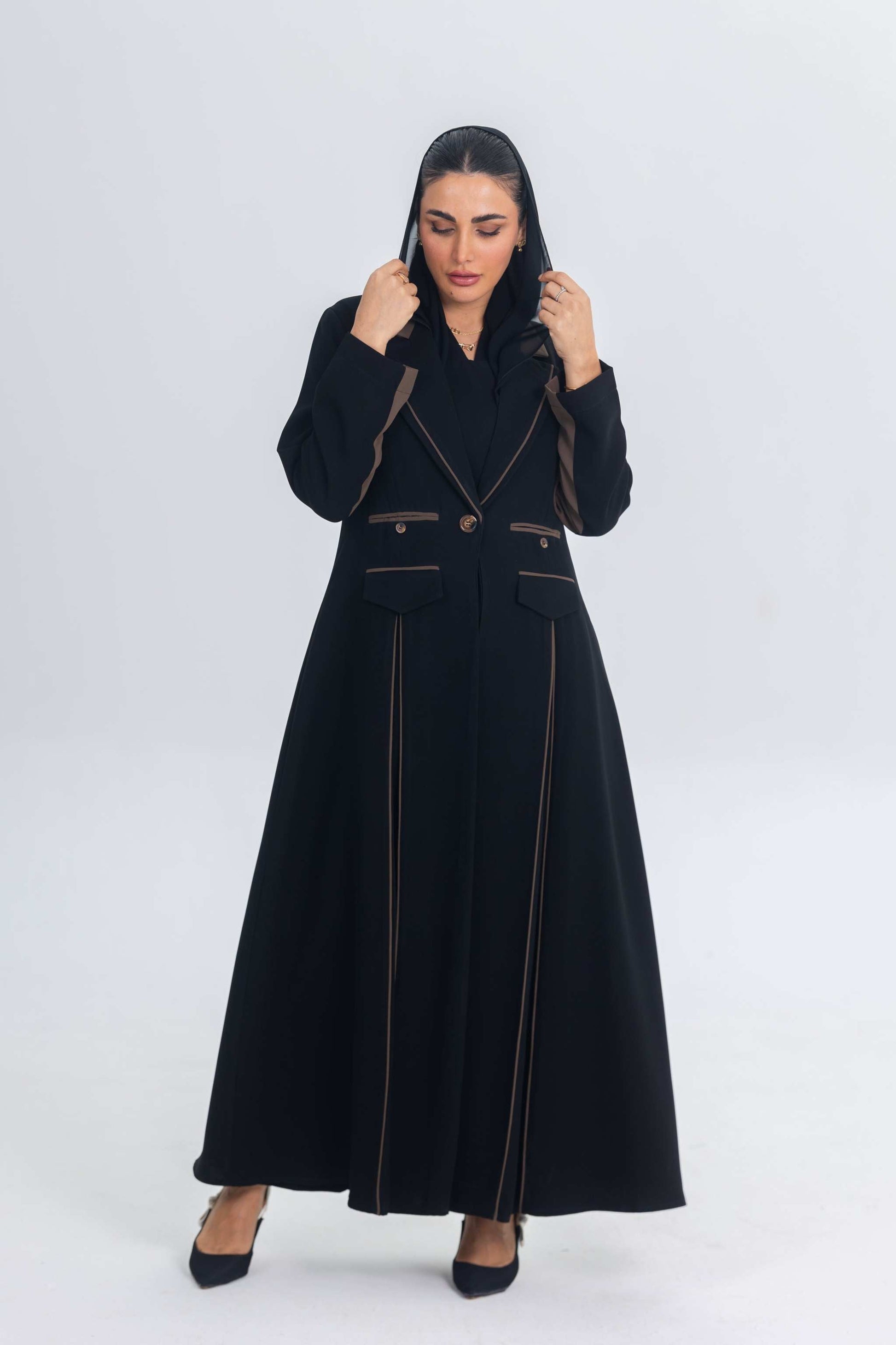 Black crepe blazer abaya with brown trims and elegant tailored silhouette worn by woman