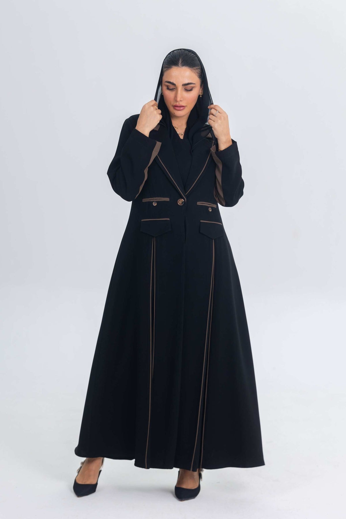 Black crepe blazer abaya with brown trims and elegant tailored silhouette worn by woman