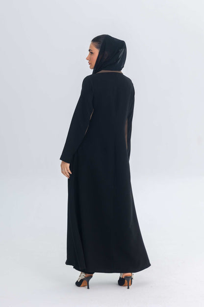 Woman wearing black crepe blazer abaya with brown trim detailing viewed from the back