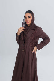 Woman wearing brown linen abaya with blazer collar and floral lace embroidery patches