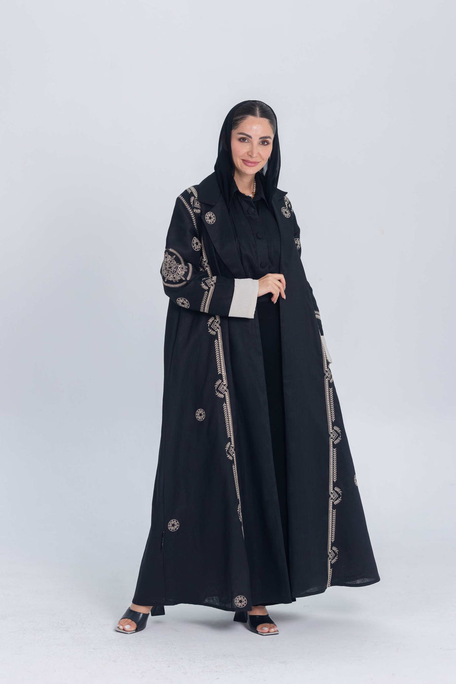 Black luxury linen abaya with beige circular embroidery and structured flow for elegant everyday or evening wear
