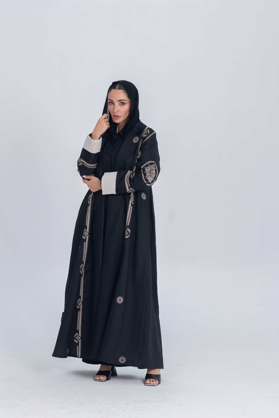 Black luxury linen abaya with beige circular embroidery, lightweight and structured design for elegant everyday and evening wear.