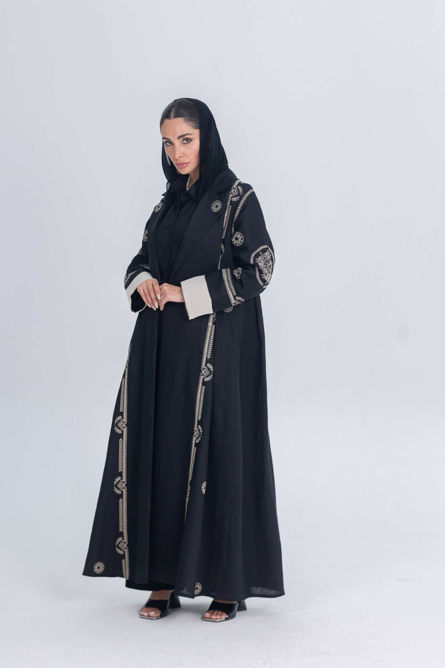 Black luxury linen abaya with beige circular embroidery, lightweight and elegant design for modern sophistication.
