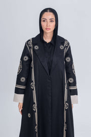 Black luxury linen abaya with beige circular embroidery and contrast cuffs, featuring a lightweight structured design and modern elegant style.