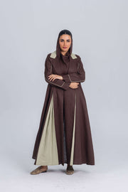Woman wearing a Mint Mocha brown linen abaya with soft mint green panels and refined detailing, showcasing elegant and modern modest fashion.