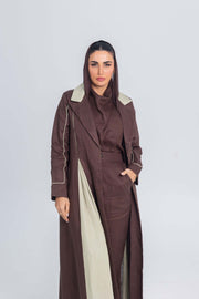 Woman wearing a Mint Mocha brown linen abaya with soft mint green linen panels and fine detailing, featuring clean lines and refined brims.