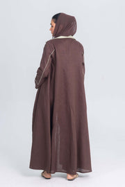 Brown linen abaya with mint green panels and fine detailing, back view showing modest design and clean lines.