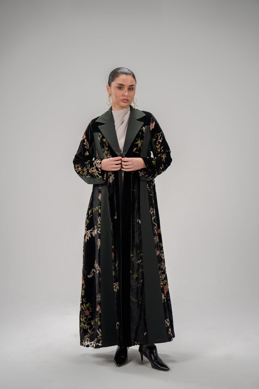 Woman wearing Evergreen floral velvet and crepe abaya with blazer cut and green lapel collar