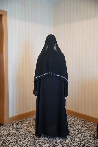 Elegant black abaya with white embroidery and matching embroidered sheila veil