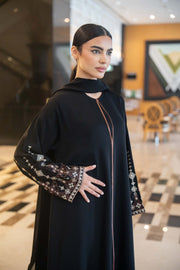 Elegant black abaya with straight cut, round neckline, and embroidered wide sleeves in coffee brown and off-white designs