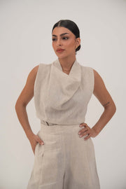 woman wearing linen beige wide leg pants with side pockets and sleeveless top