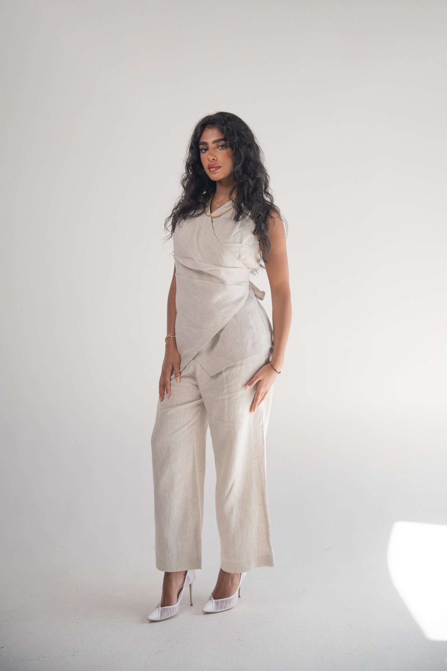 Sleeveless Almond Beige Blouse with front wrap design and soft pleats for elegant drape