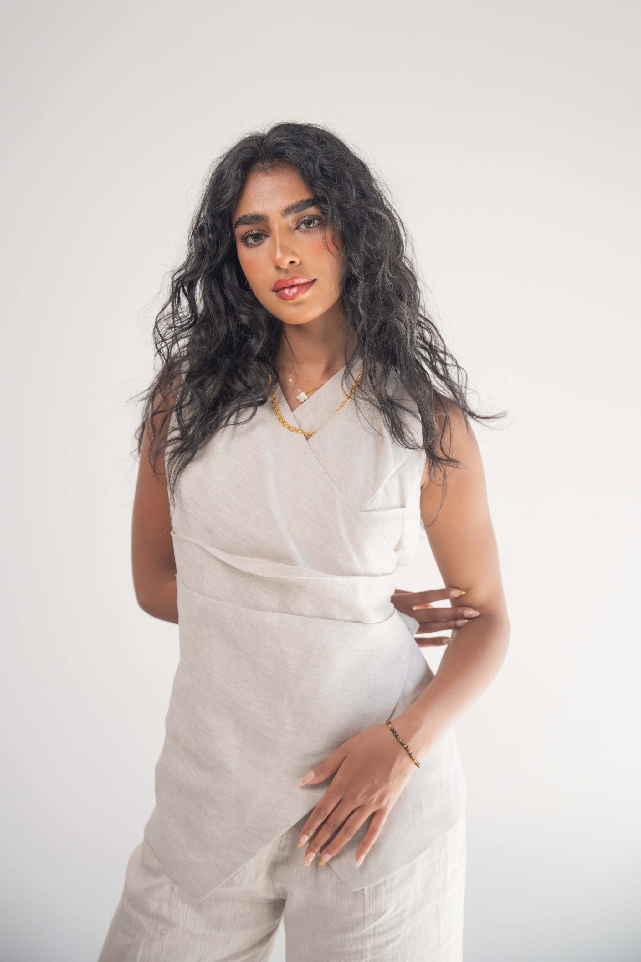 Sleeveless Almond Beige Blouse with front wrap and soft pleats, elegant and comfortable design