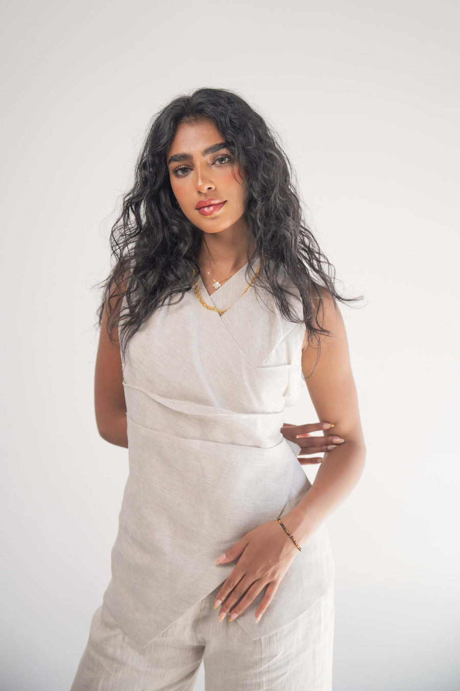 Sleeveless Almond Beige Blouse with front wrap and soft pleats, elegant and comfortable design