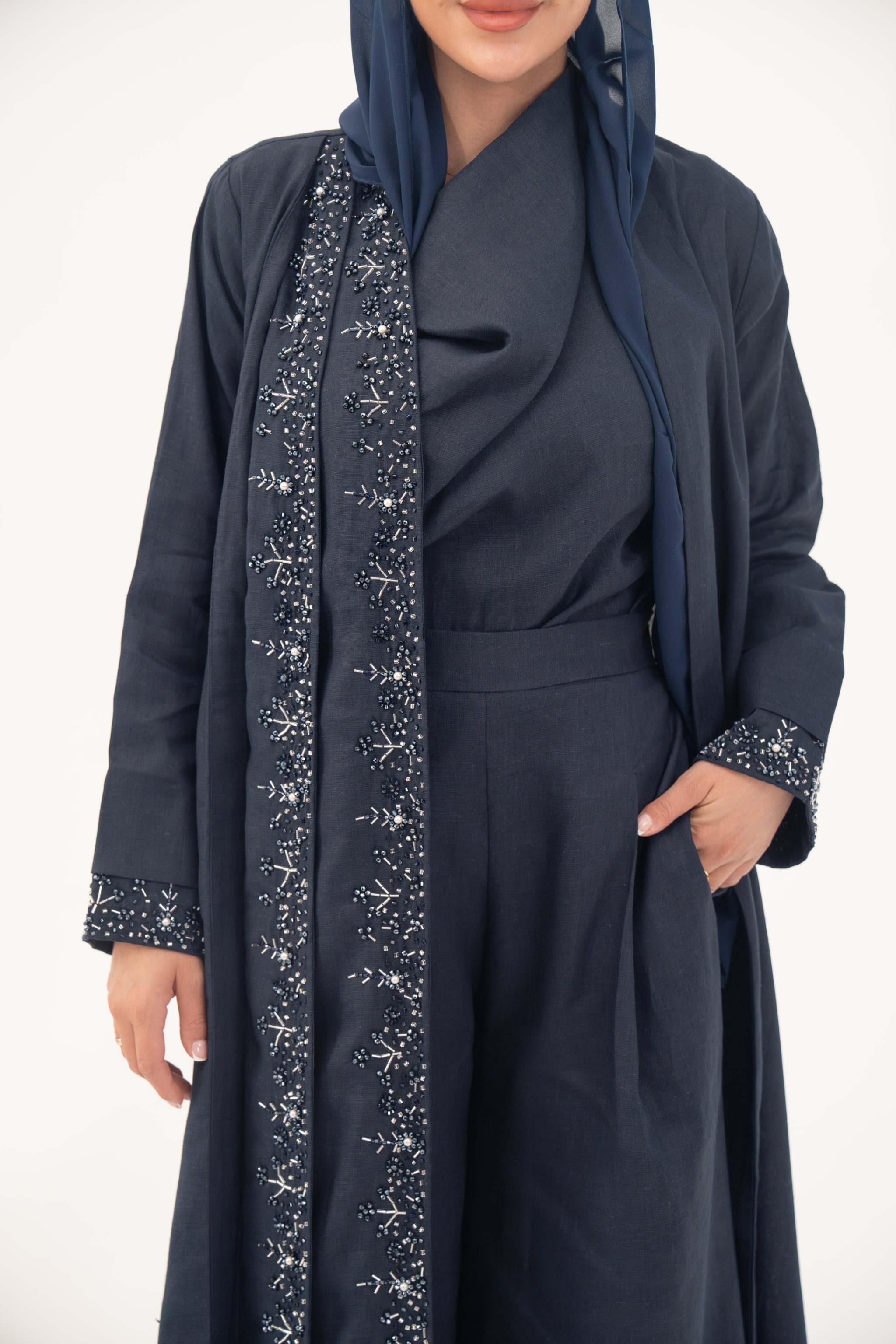 High-quality linen abaya with delicate shak beading on front panels and cuffs, open-front flowy design with structured shoulders