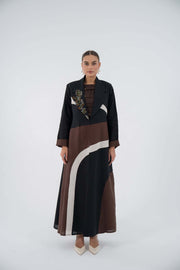 Curve Bloom Linen Abaya with black base, brown and white curved panels, floral embroidery, lightweight linen, flowing blazer style, relaxed fit.