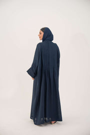 Woman wearing full-length open-front abaya navy blue linen with vertical stitched pleats