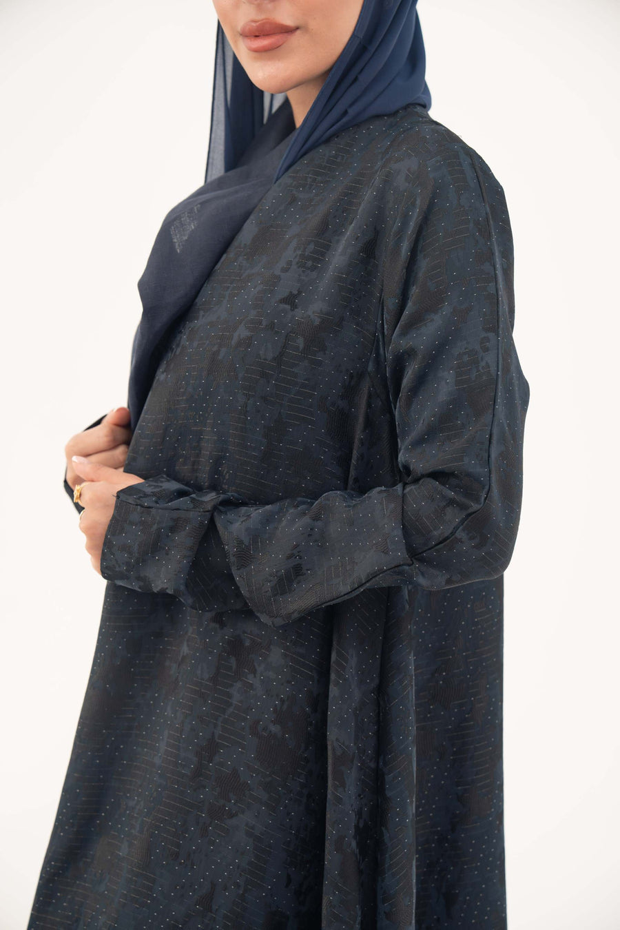 Elegant navy jacquard abaya with subtle textured pattern and soft shimmer, featuring a flowing cut for a sophisticated drape.