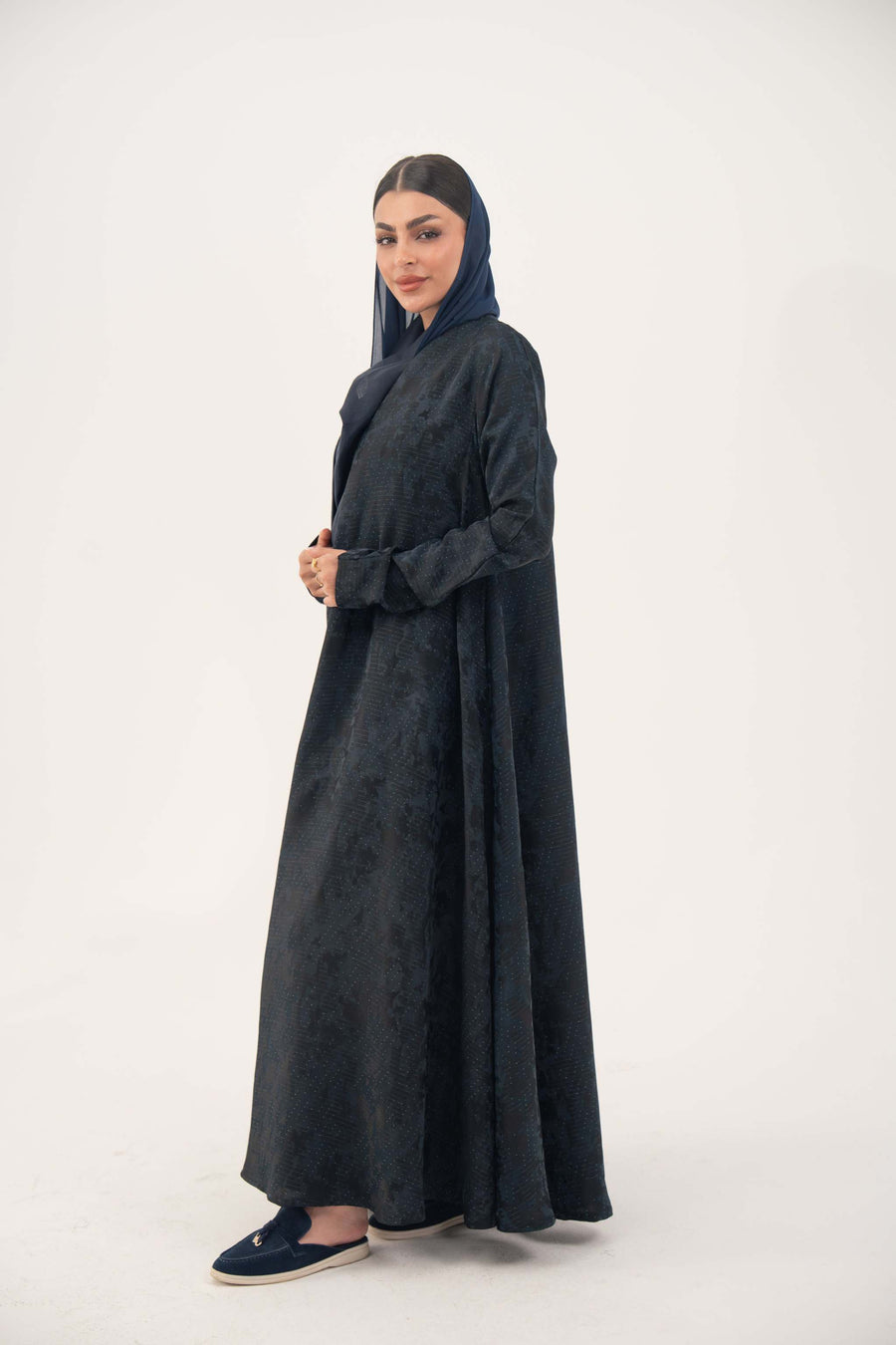 Elegant navy jacquard abaya with subtle textured pattern and soft shimmer, featuring a flowing cut for a sophisticated drape.