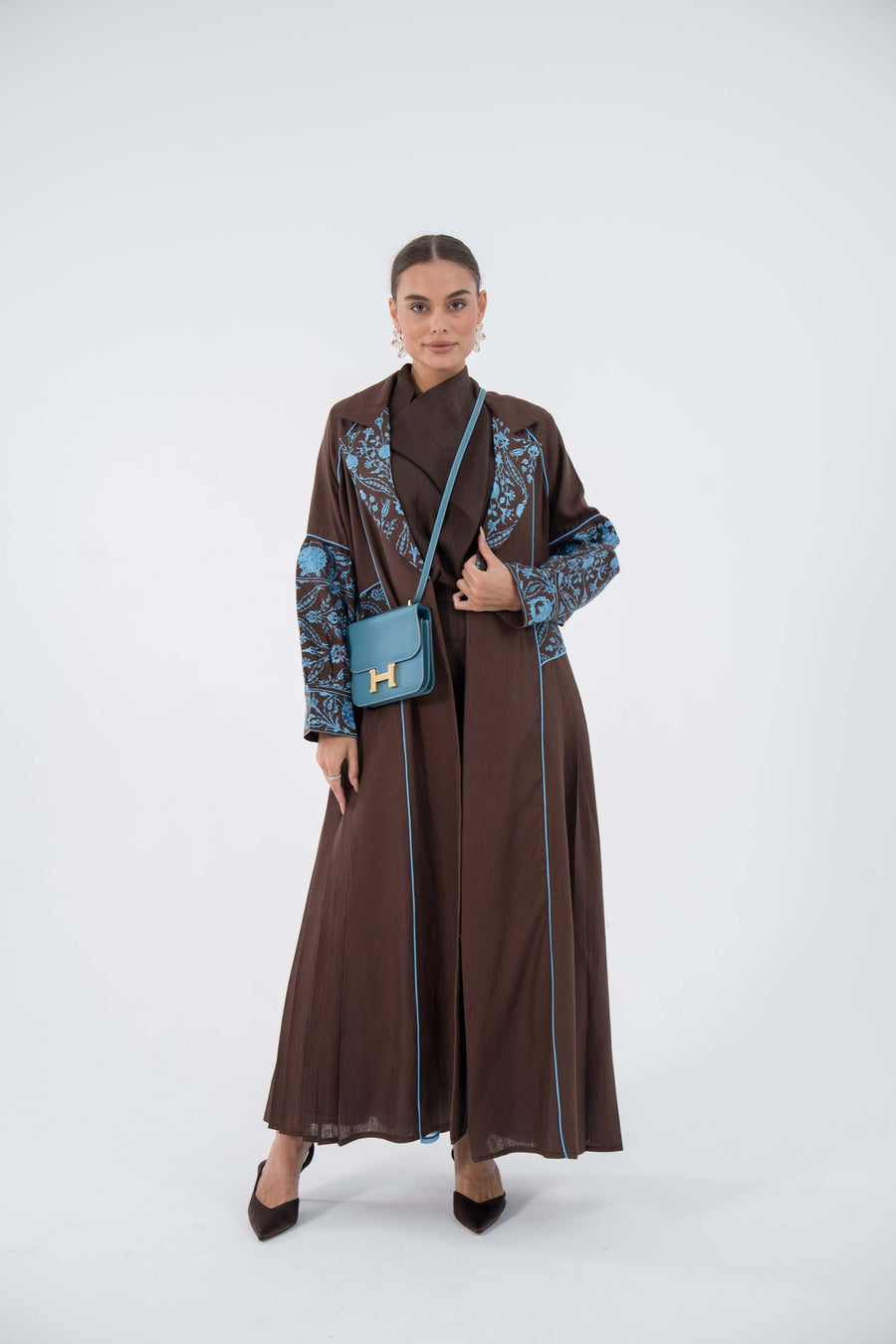 Azure Vine Linen Abaya in deep brown with blue embroidery and chiffon lining, flowing blazer-style cut.