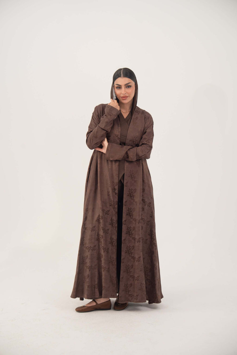 Warm cocoa brown jacquard silk abaya with subtle floral pattern and long sleeves in relaxed A-line cut