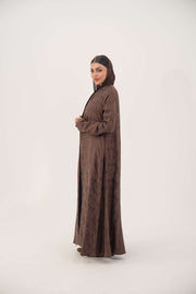 Full-length jacquard silk abaya in warm cocoa brown with subtle floral pattern and A-line relaxed fit.