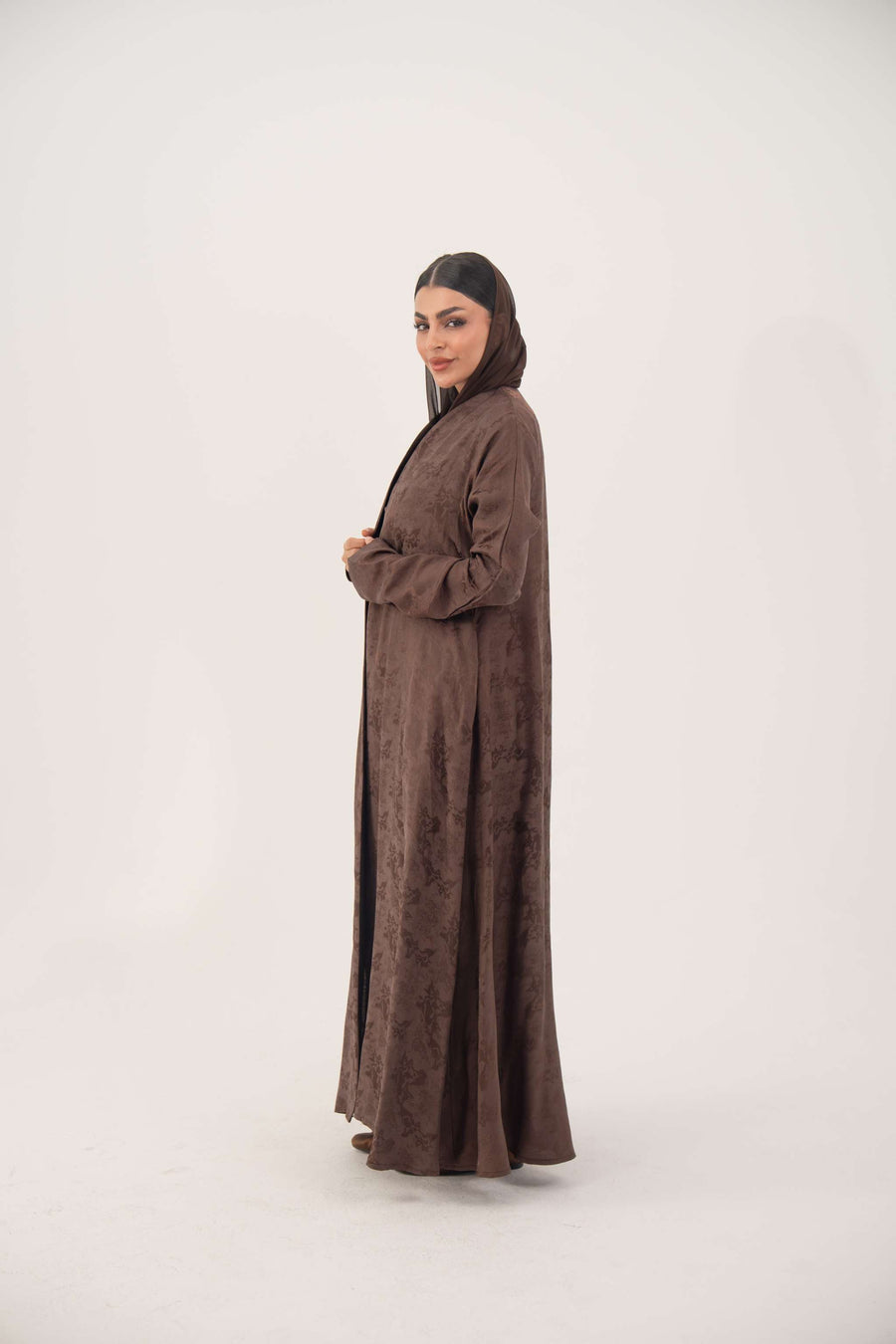 Full-length jacquard silk abaya in warm cocoa brown with subtle floral pattern and A-line relaxed fit.