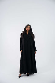 Woman wearing ebony blazer crepe abaya with intricate embroidery and relaxed fit long sleeves 854
