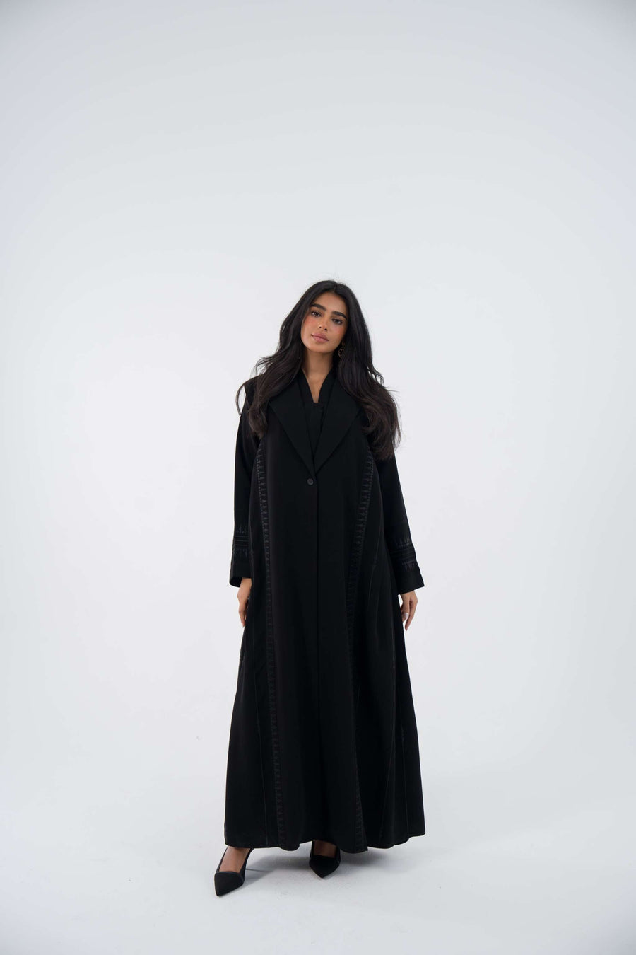 Woman wearing ebony blazer crepe abaya with intricate embroidery and relaxed fit long sleeves 854