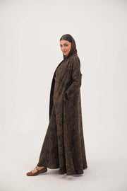 Woman wearing a lightweight espresso brown jacquard silk abaya with subtle tonal pattern and side pockets