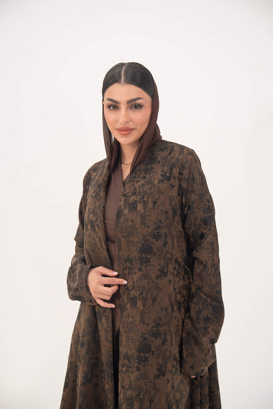 woman wearing lightweight jacquard silk abaya in rich espresso brown with tonal pattern and open-front design