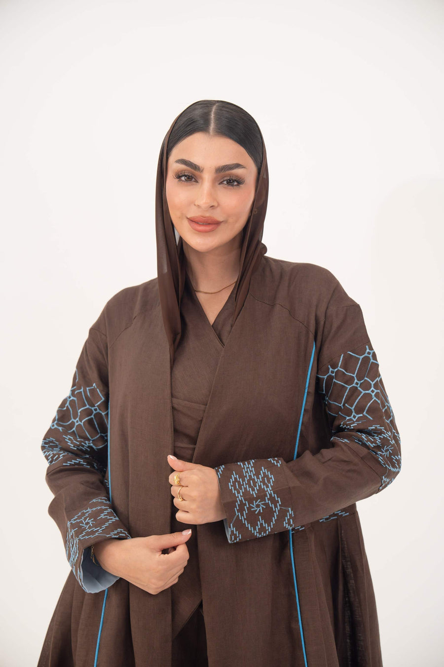 Mocha brown linen-blend abaya with sky-blue embroidery, batwing sleeves, and open front design.