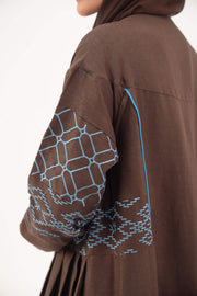 Mocha brown linen-blend abaya with sky-blue embroidery and blue piping accents on sleeves and seams