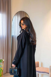 Elegant black crepe abaya with delicate leaf embroidery on cuffs and hem, featuring a lightweight fabric for comfortable all-day wear - Night Leaf
