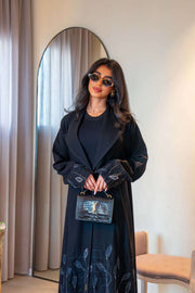 Elegant black crepe abaya with delicate leaf embroidery on cuffs and hem, featuring a lightweight fabric for comfortable all-day wear - Night Leaf