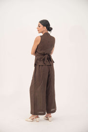 Woman wearing sleeveless brown linen vest with wrap-style back tied at the waist and matching wide-leg pants-Brown Vest