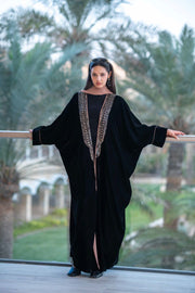 Elegant black velvet Ayla abaya with intricate embellishments and flowing loose silhouette.