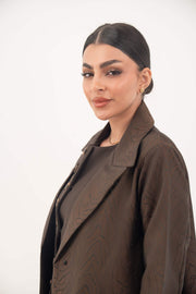 Woman wearing dark chocolate jacquard blazer abaya with sharp lapels and structured tailoring
