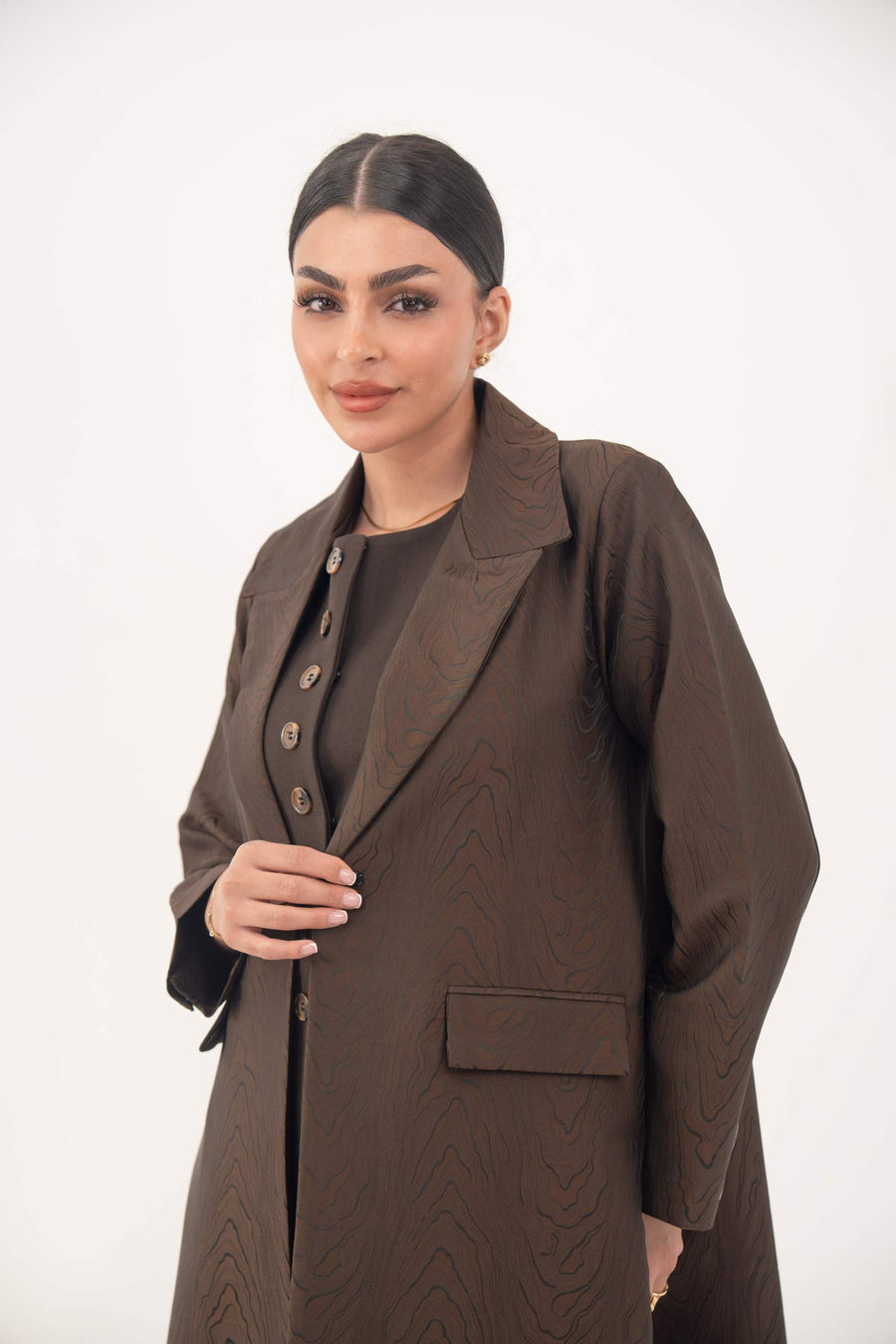 Brown jacquard blazer abaya with sharp lapels and structured tailoring worn by woman