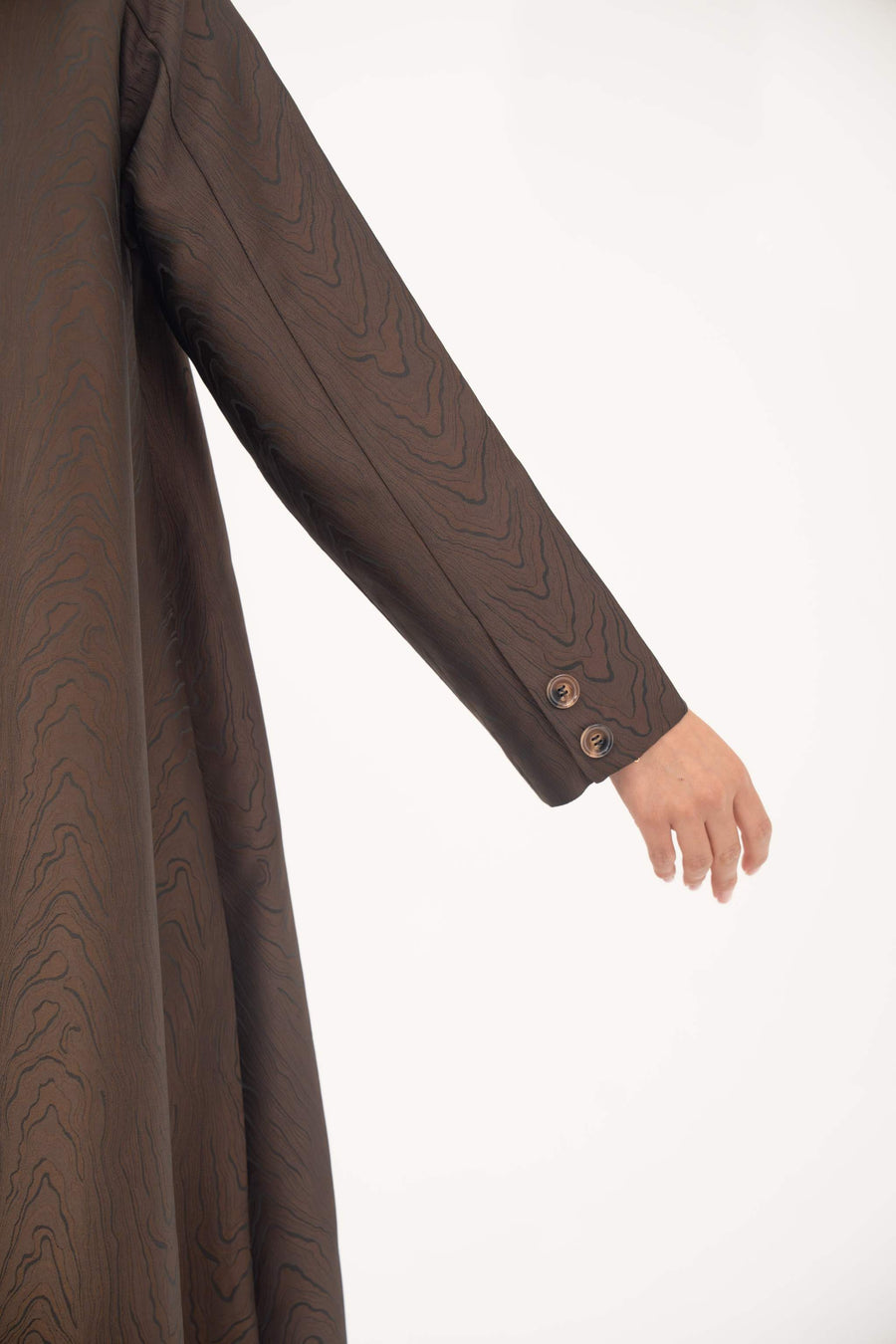 Brown jacquard blazer abaya with textured pattern, sharp lapels, structured tailoring, and button details on sleeve.