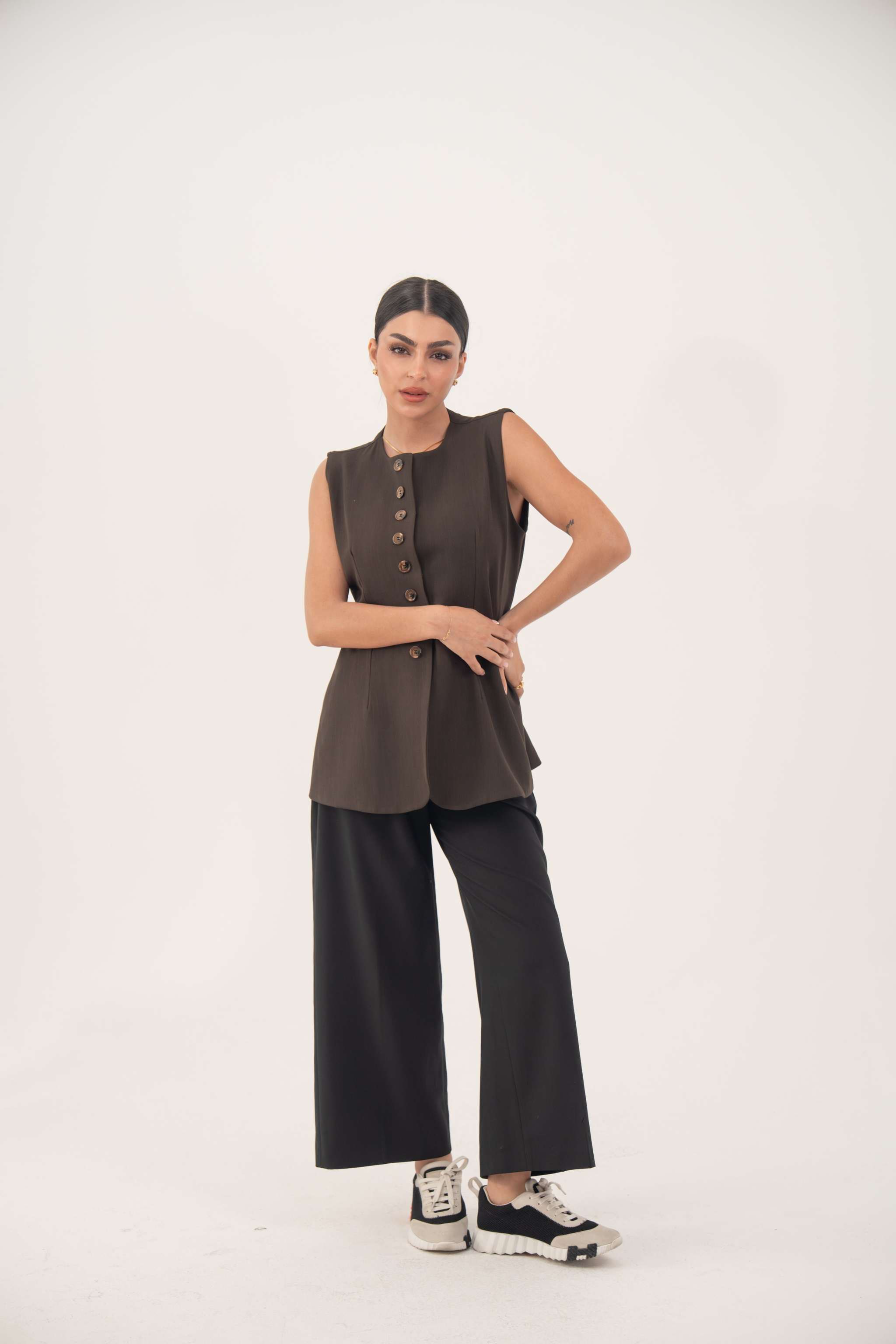Brown crepe sleeveless vest with front button details and modern tailored fit.