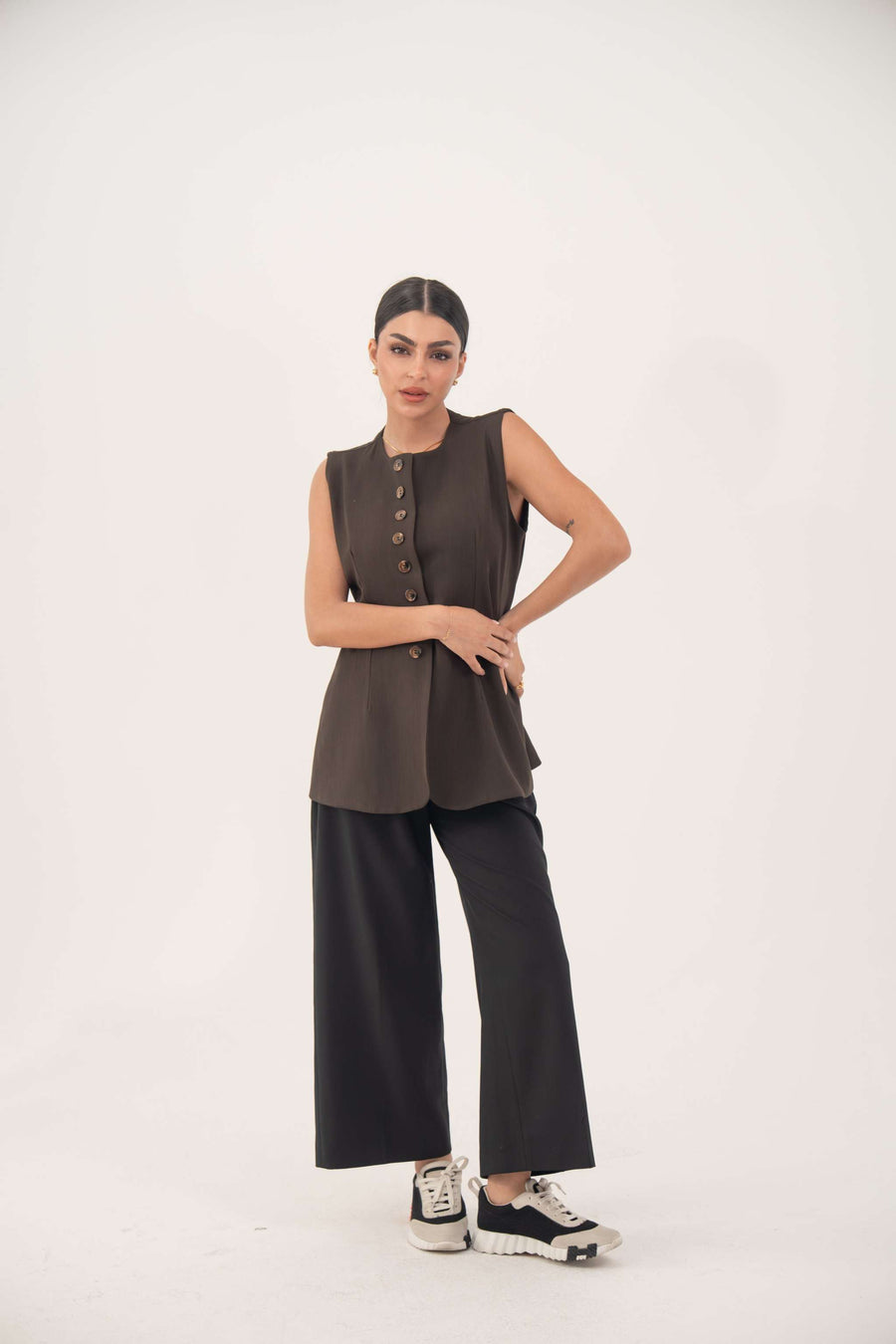 Brown crepe sleeveless vest with front button details and modern tailored fit.