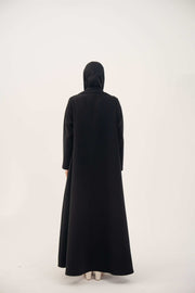 Back view of black Layal blazer abaya with crepe and satin fabric, notched collar, and flowing long crepe body.