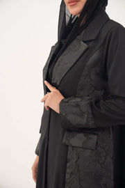 Black jacquard blazer abaya with textured pattern, structured silhouette, and classic lapels for formal wear