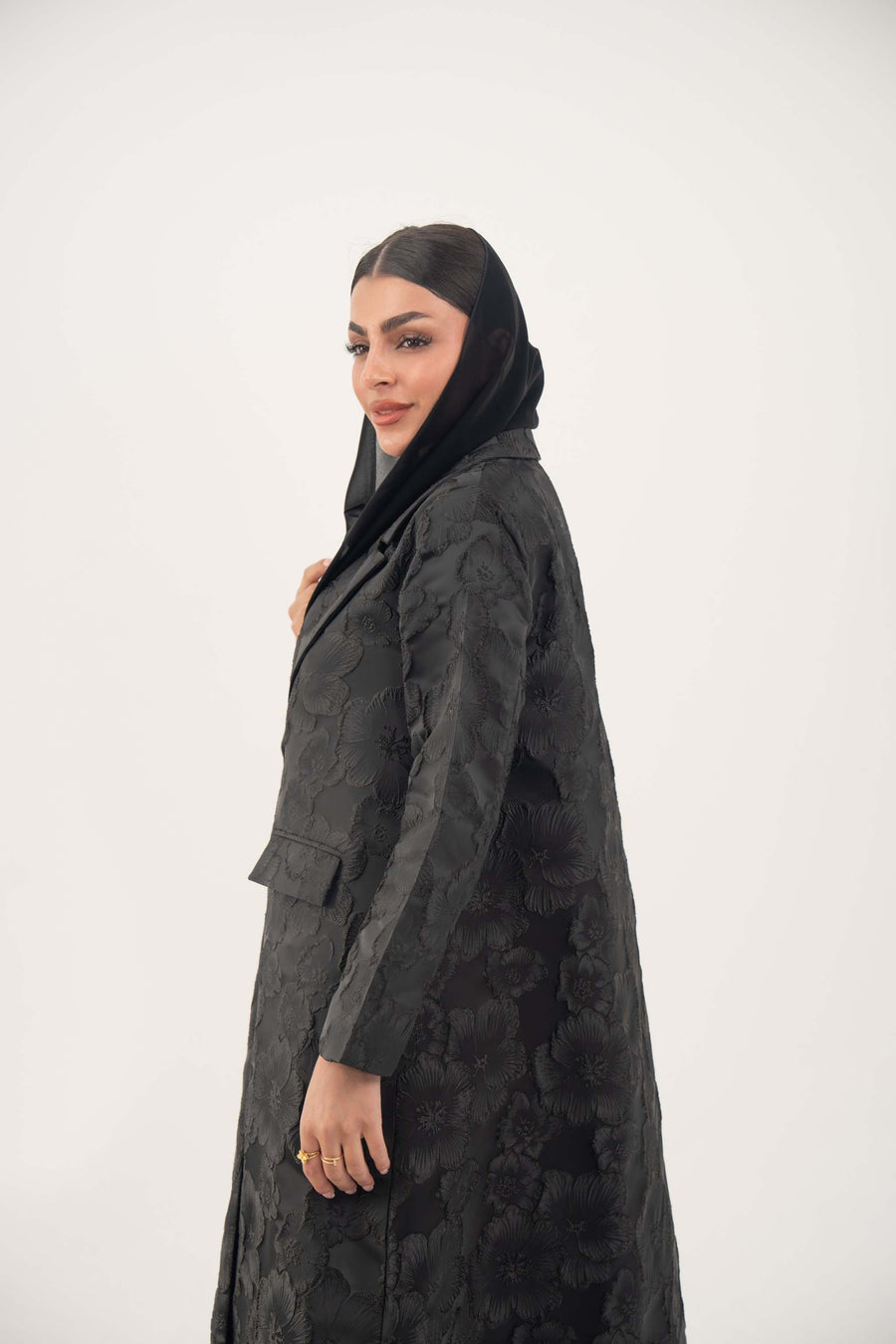 woman wearing elegant black jacquard blazer abaya with textured pattern and classic lapels